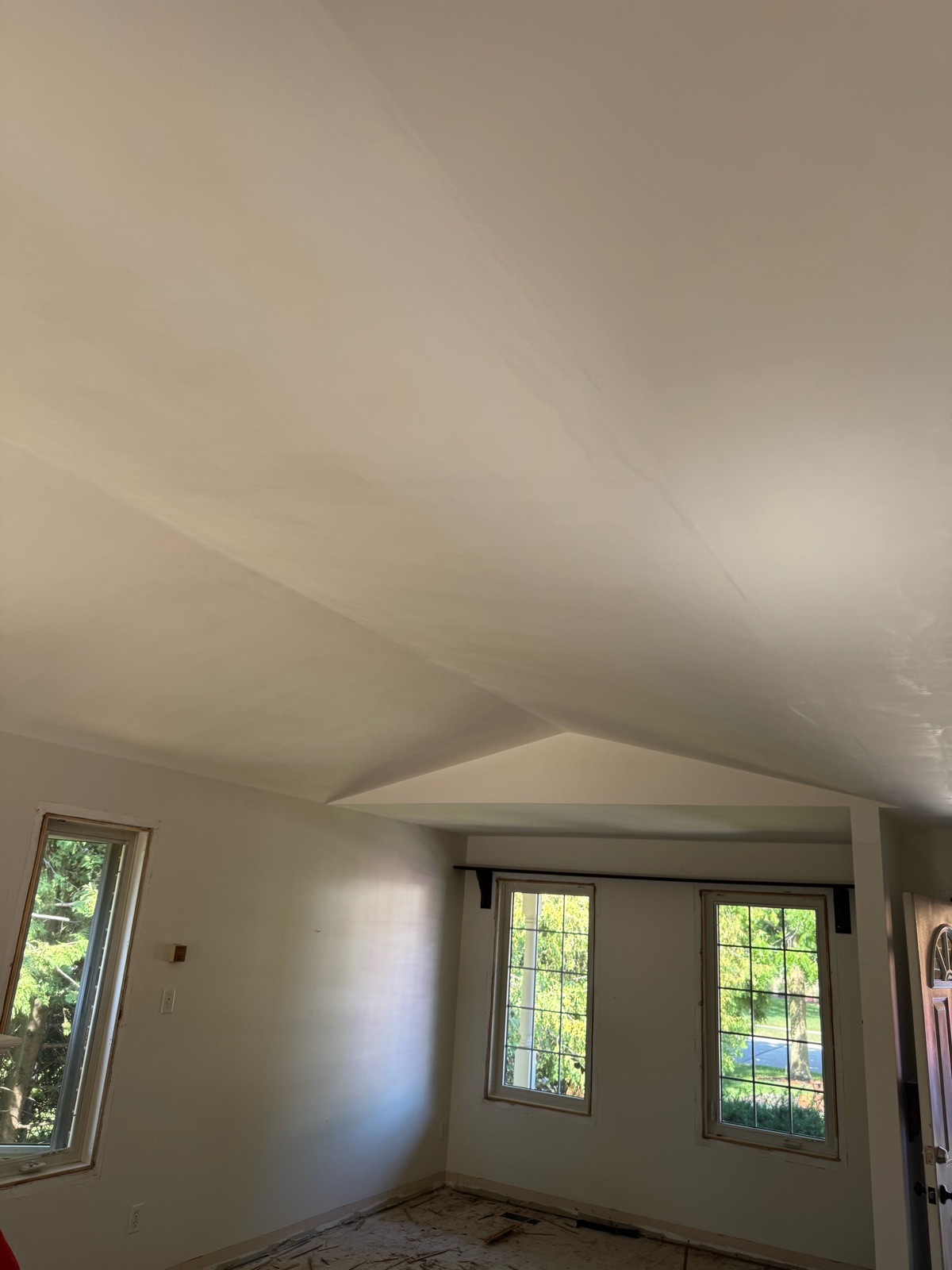 Smooth vaulted ceiling above the front windows after texture removal and skimming