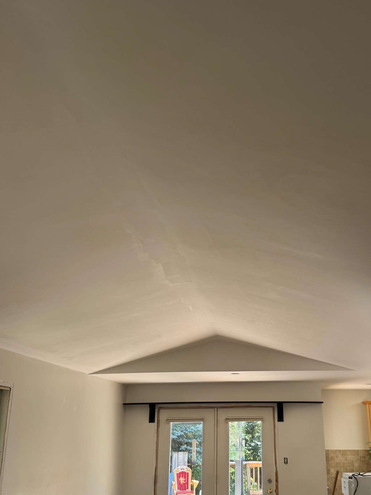 The same vaulted ceiling after the orange peel texture was removed and the surface skimmed smooth