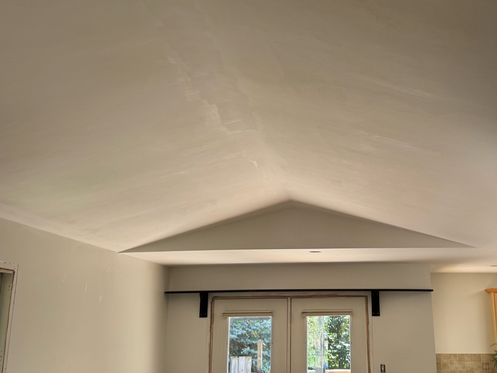 Vaulted living room ceiling skimmed smooth after the orange peel texture was removed